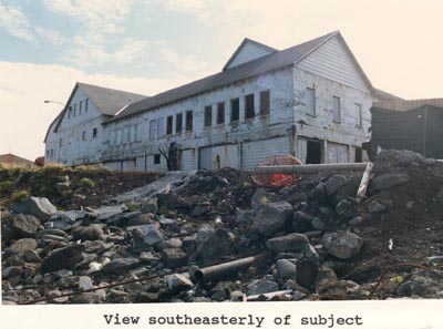 Photo of southeasterly view of large white building.